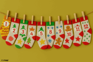 Guirlande de chaussettes de l’Avent suspendue sur un mur décoré